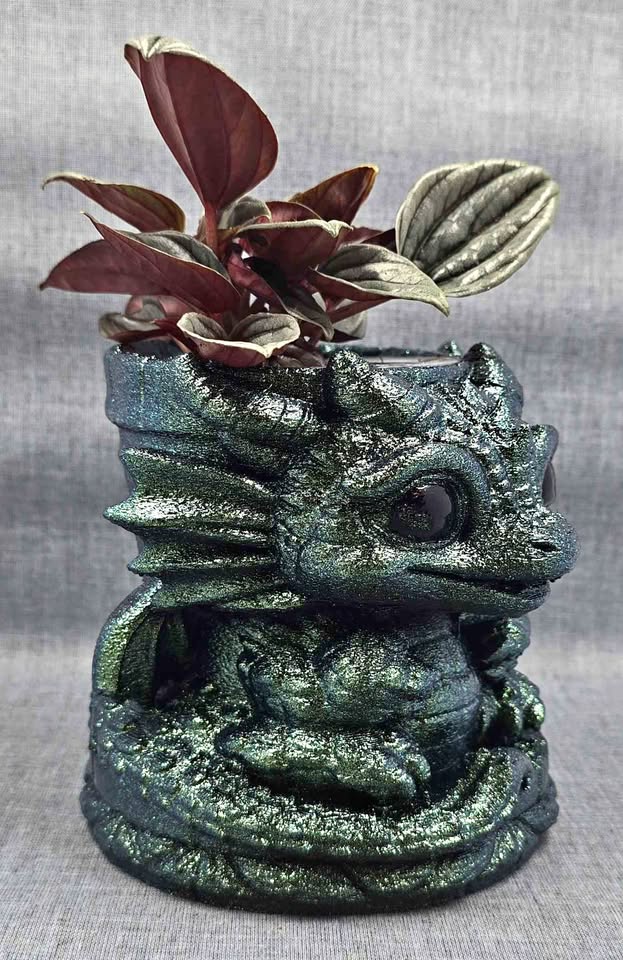 Handcrafted iridescent green dragon planter with a Peperomia caperata Napoli Nights.