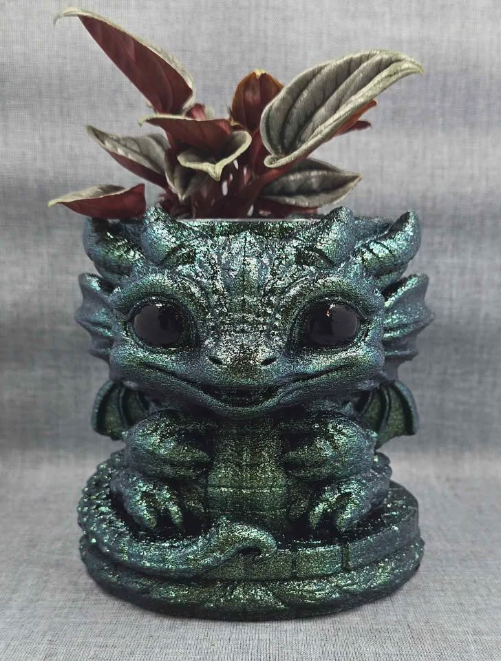 Handcrafted iridescent green dragon planter with a Peperomia caperata Napoli Nights.