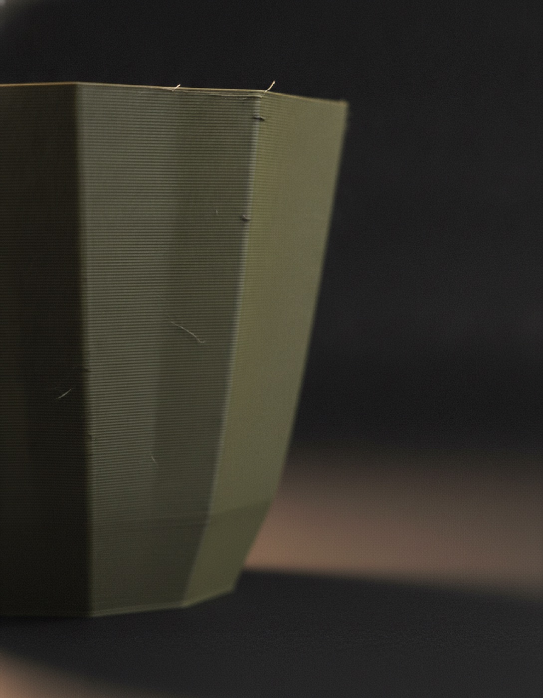 Macro close-up of the visible horizontal layer lines on the side of an Edgy Root pot.